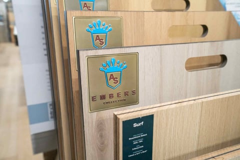 Wooden crates with blue crown logos and Beers label stacked together showing brewery product packaging