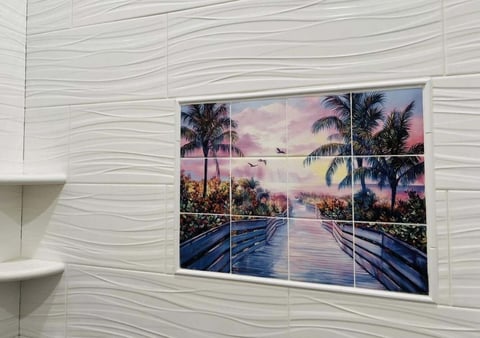 Tiled wall art showing a sunset tropical scene with palm trees and reflective pool water